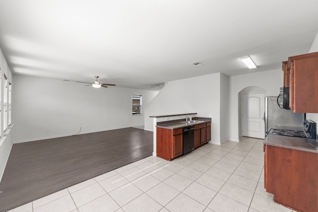 kitchen with sink, ceiling fan, black dishwasher, light tile patterned flooring, and range