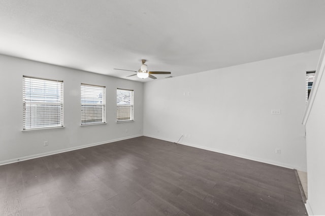 spare room featuring dark hardwood / wood-style floors, a healthy amount of sunlight, and ceiling fan