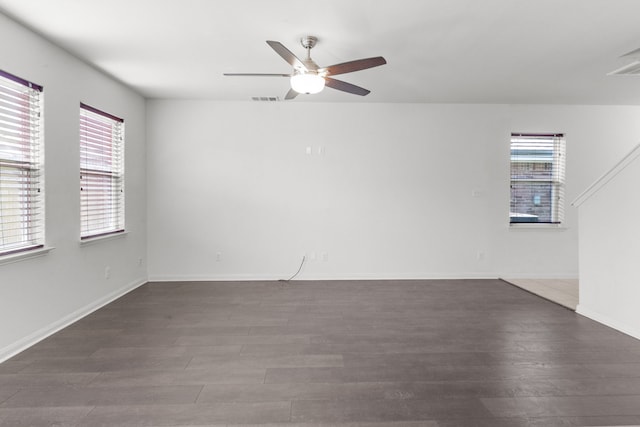 unfurnished room with ceiling fan and dark wood-type flooring