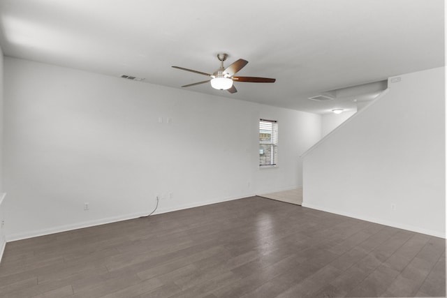 unfurnished room with dark hardwood / wood-style floors and ceiling fan