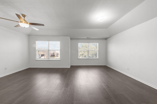 spare room featuring ceiling fan, dark hardwood / wood-style flooring, and vaulted ceiling