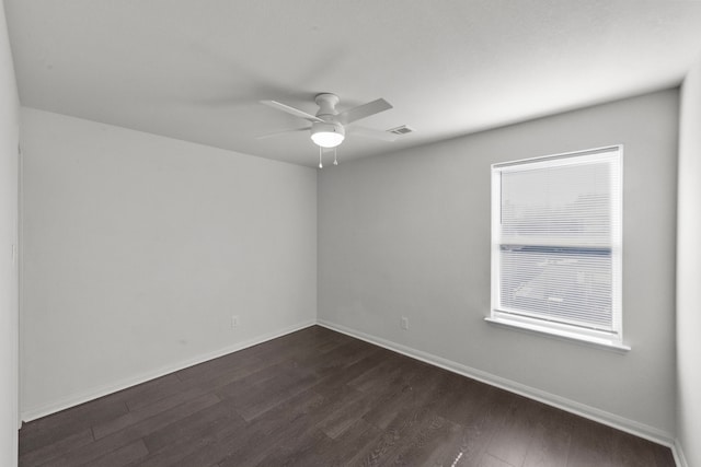 empty room featuring ceiling fan and dark hardwood / wood-style flooring