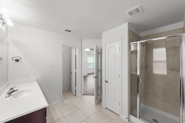 bathroom with vanity, tile patterned floors, ceiling fan, and a shower with shower door