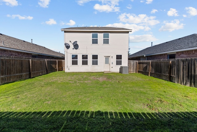 rear view of property featuring a yard