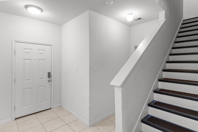 foyer entrance with light tile patterned flooring