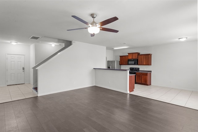 unfurnished living room featuring ceiling fan and light tile patterned floors