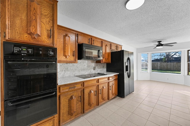 kitchen featuring light tile patterned floors, ceiling fan, tasteful backsplash, black appliances, and a textured ceiling