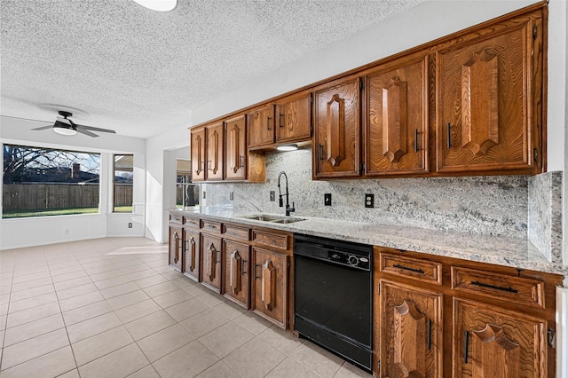 kitchen featuring black dishwasher, sink, backsplash, light tile patterned floors, and light stone counters