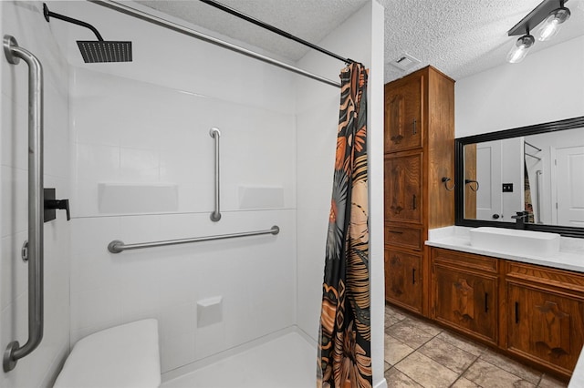 bathroom with vanity, a textured ceiling, and a shower with curtain