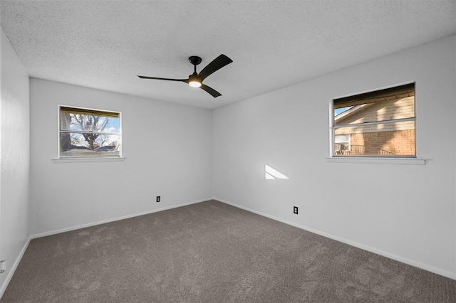 unfurnished room featuring ceiling fan, carpet floors, and a textured ceiling