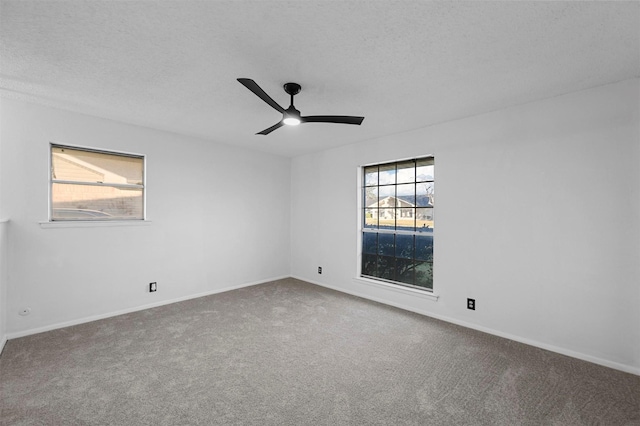 unfurnished room featuring ceiling fan, carpet flooring, and a textured ceiling