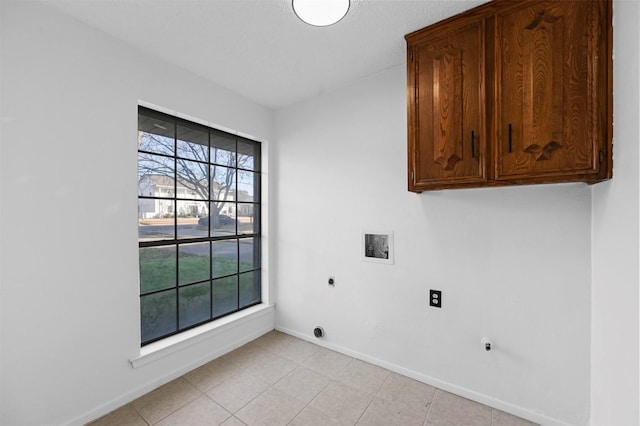 laundry area with cabinets, washer hookup, hookup for an electric dryer, and a wealth of natural light