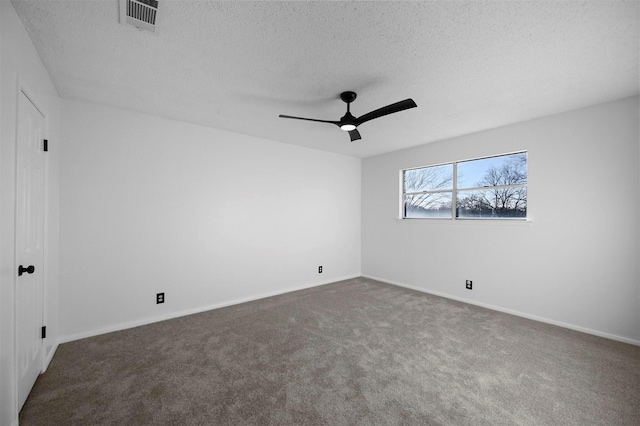 carpeted empty room with ceiling fan and a textured ceiling