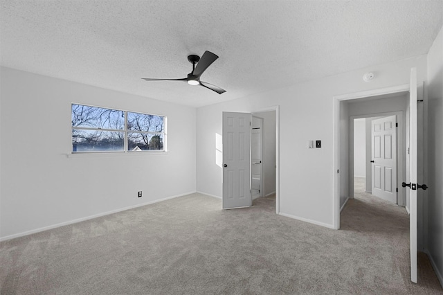 unfurnished bedroom featuring light carpet, a textured ceiling, and ceiling fan