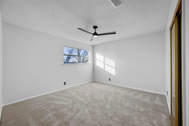 unfurnished bedroom with ceiling fan, light colored carpet, a closet, and a textured ceiling