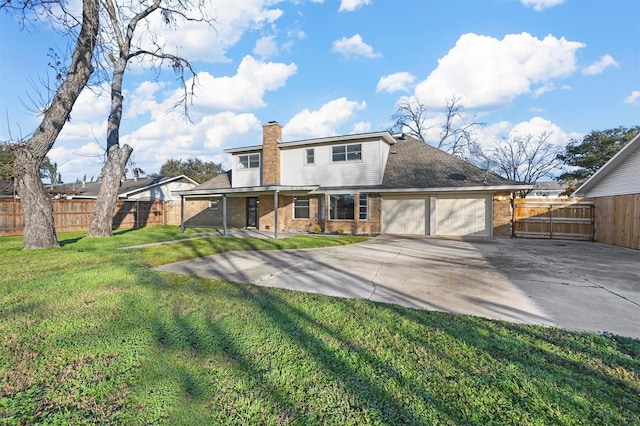 back of property with a garage and a yard