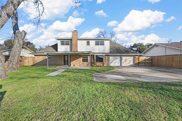 rear view of property featuring a garage and a lawn