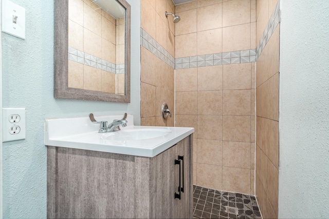 bathroom featuring vanity and a tile shower