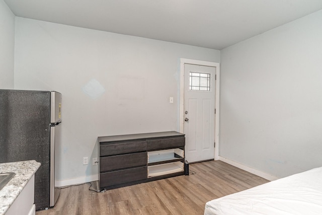 interior space with stainless steel refrigerator and light hardwood / wood-style flooring