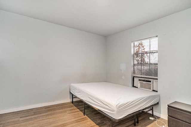 bedroom featuring hardwood / wood-style floors and cooling unit