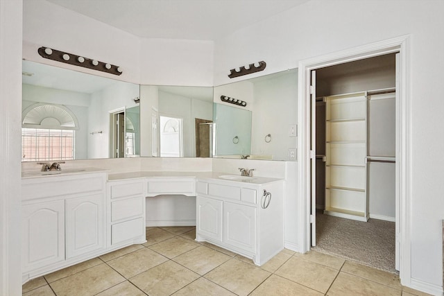 bathroom featuring tile patterned flooring, vanity, and a shower with door