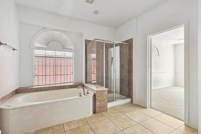 bathroom featuring tile patterned floors and separate shower and tub