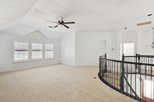 carpeted spare room with ceiling fan and lofted ceiling