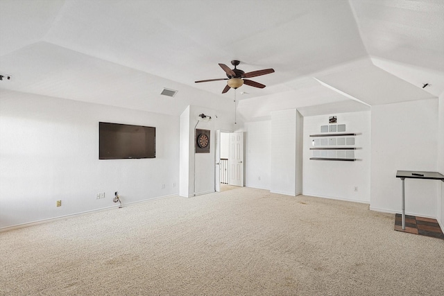 unfurnished living room with ceiling fan, carpet, and lofted ceiling