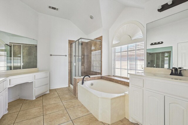 bathroom with tile patterned flooring, vanity, and plus walk in shower