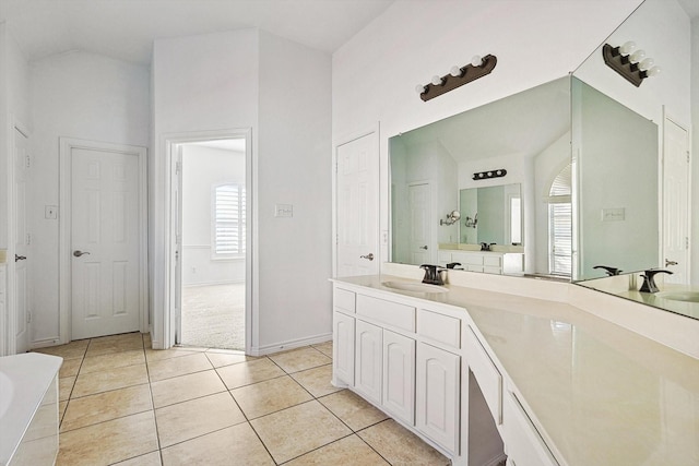 bathroom featuring tile patterned floors, vanity, and lofted ceiling