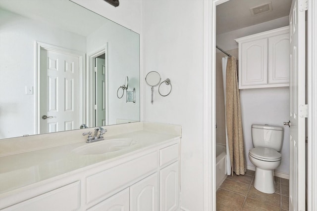 full bathroom featuring tile patterned floors, shower / bathtub combination with curtain, vanity, and toilet