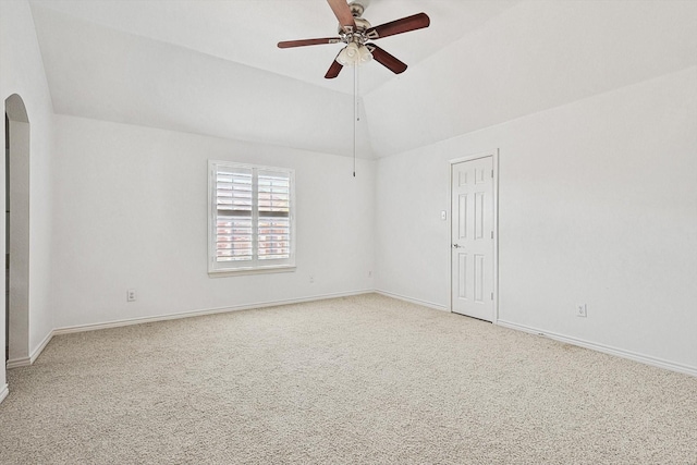 spare room with carpet flooring, ceiling fan, and vaulted ceiling