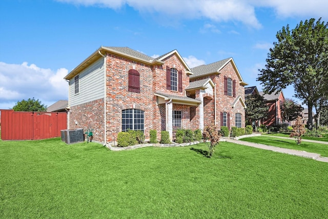 view of front of home featuring a front lawn and cooling unit