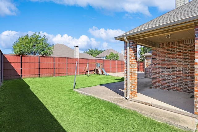 view of yard with a playground and a patio area