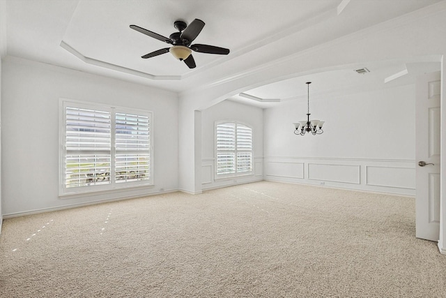 unfurnished room with a tray ceiling, carpet flooring, and ceiling fan with notable chandelier