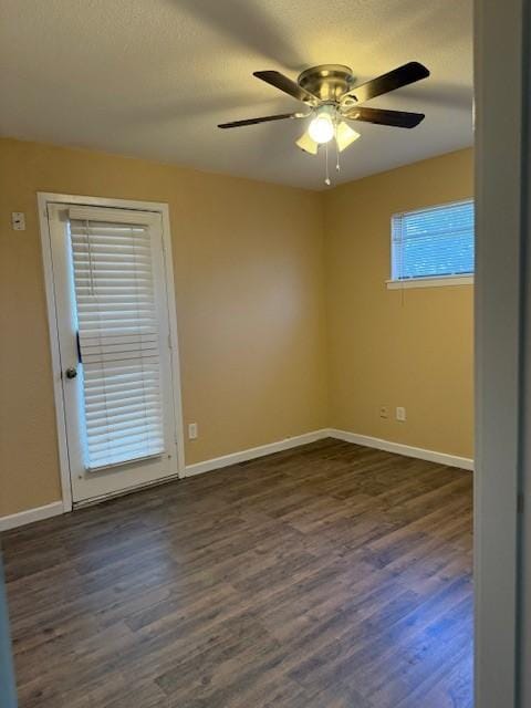 empty room featuring a textured ceiling, dark hardwood / wood-style flooring, and ceiling fan