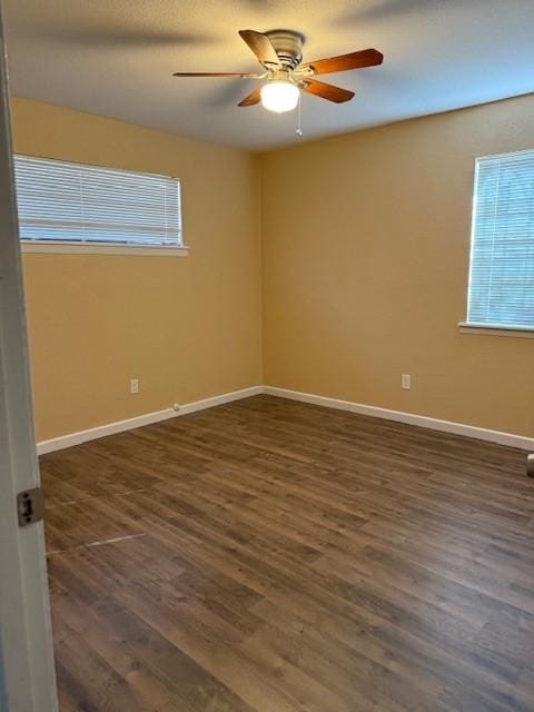 spare room featuring dark hardwood / wood-style flooring and ceiling fan