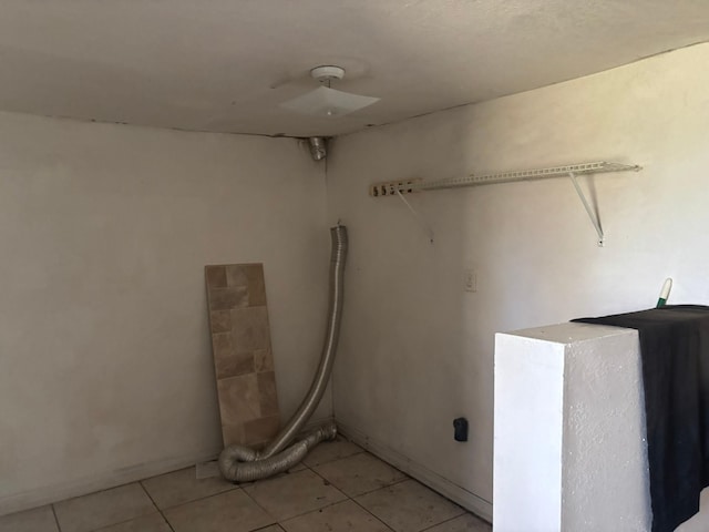 clothes washing area featuring light tile patterned floors