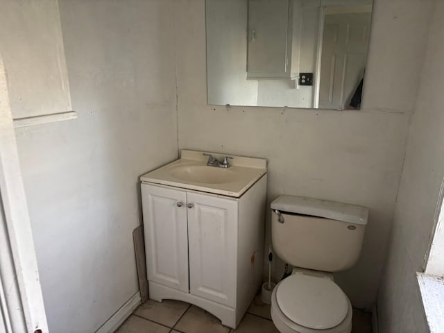 bathroom with vanity, tile patterned floors, and toilet