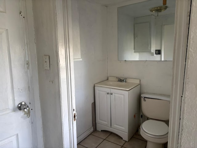 bathroom with vanity, tile patterned flooring, and toilet