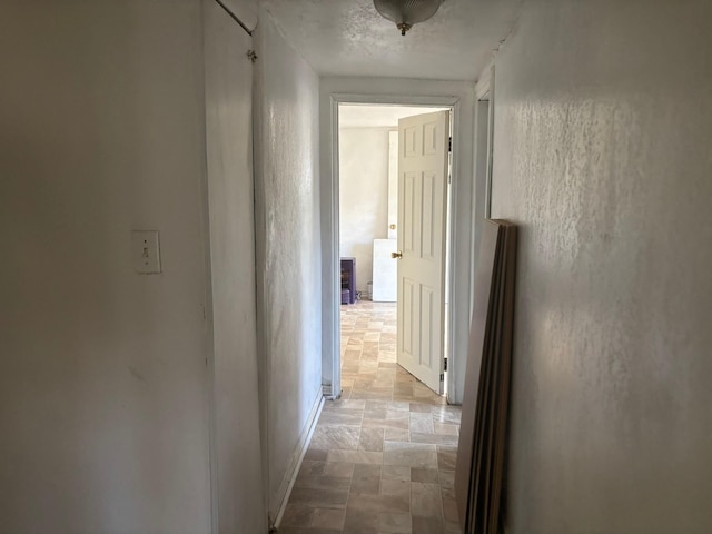 hallway featuring a textured ceiling