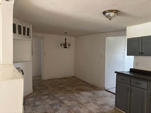 unfurnished dining area featuring an inviting chandelier