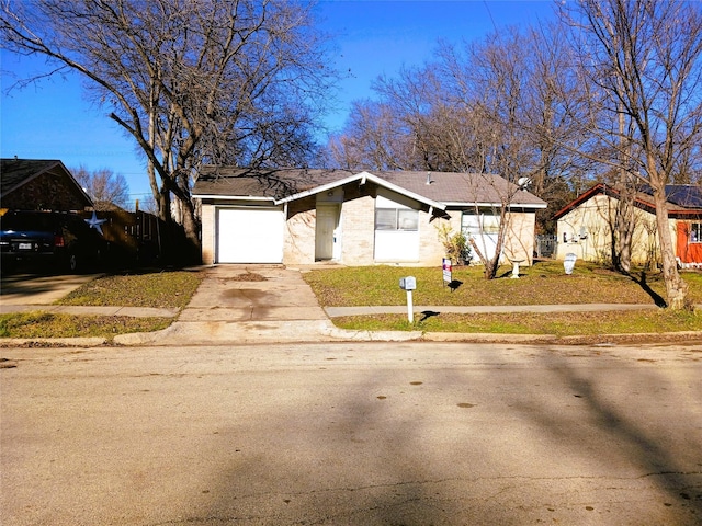 view of front facade with a garage and a front lawn