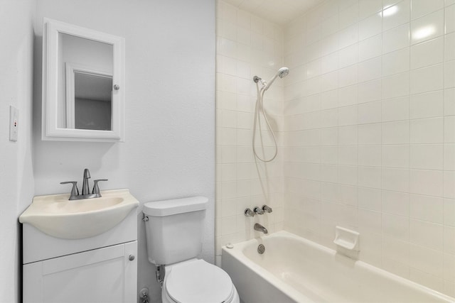 full bathroom featuring vanity, tiled shower / bath combo, and toilet