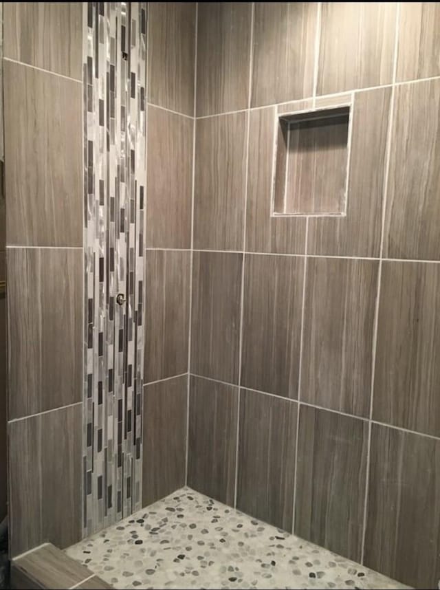 bathroom with a tile shower