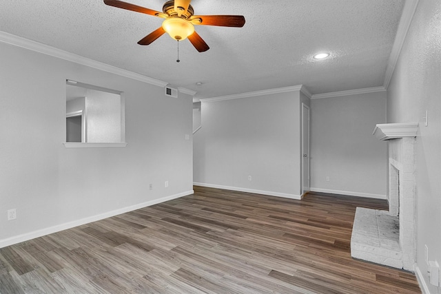 unfurnished living room featuring ceiling fan, crown molding, hardwood / wood-style floors, and a textured ceiling