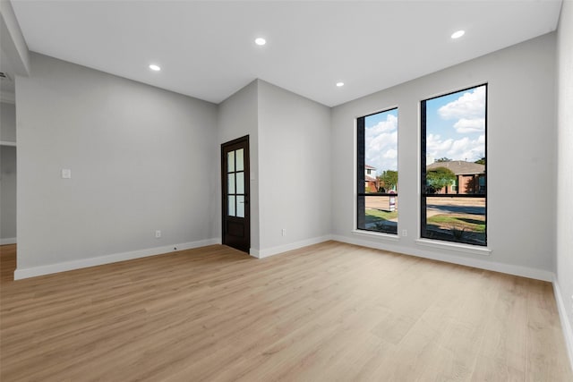 spare room with light hardwood / wood-style flooring