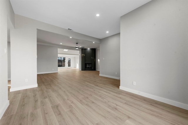 unfurnished living room featuring ceiling fan and light hardwood / wood-style floors