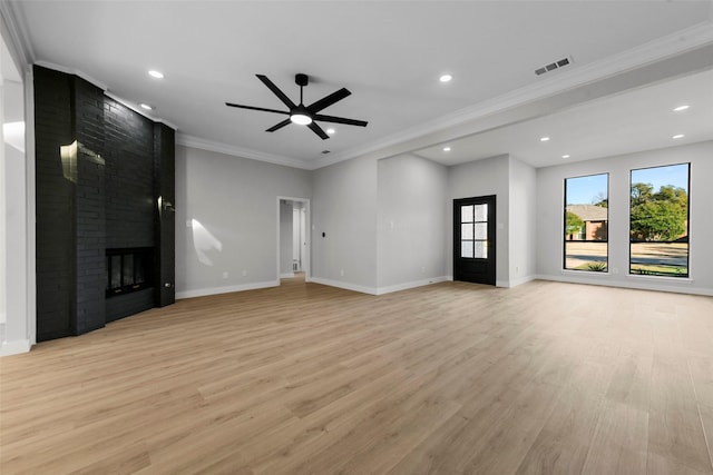 unfurnished living room with light hardwood / wood-style floors, a brick fireplace, ceiling fan, and ornamental molding