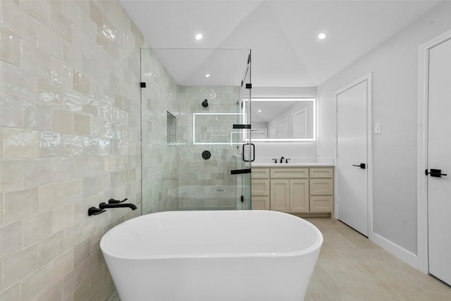 bathroom with separate shower and tub, tile patterned floors, vaulted ceiling, vanity, and tile walls